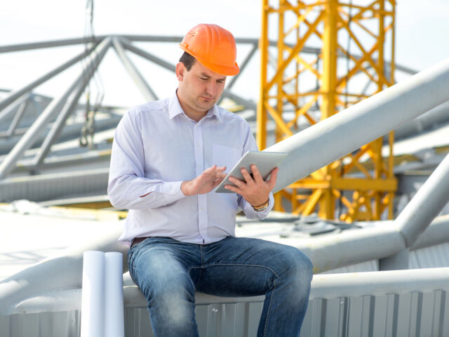 A Foreman With Digital Tablet At The Construction Supervising Th